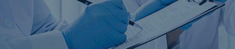 Gloved laboratory professional completing a compliance checklist on a clipboard.